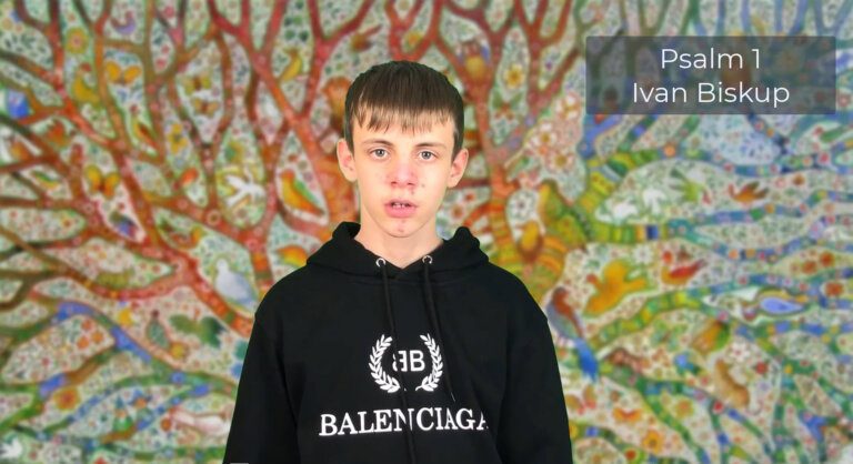 Teenage boy with hoodie sweatshirt standing in front of a colorful background and speaking