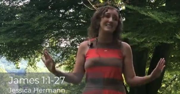 Young woman speaking while standing outdoors with trees in the background