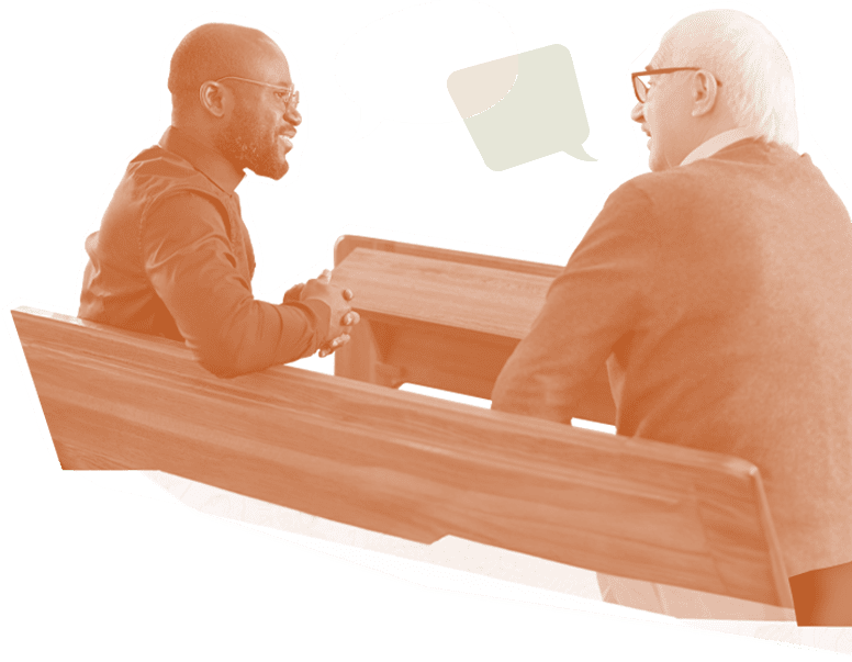 Young man and old man sitting on a church pew and talking